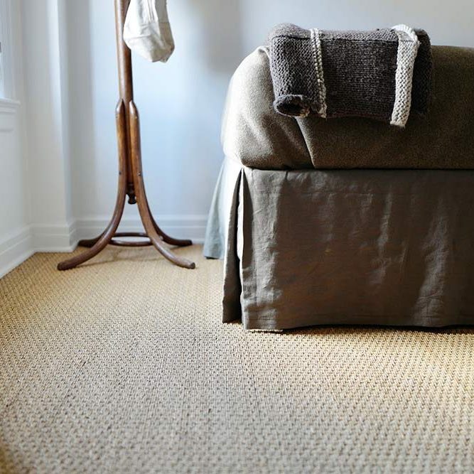 neutral colored seagrass rug in bedroom