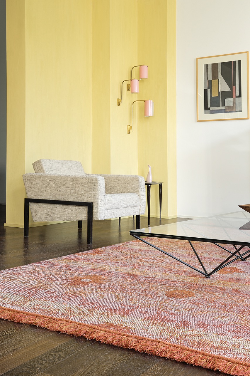 orange color rug and yellow walls