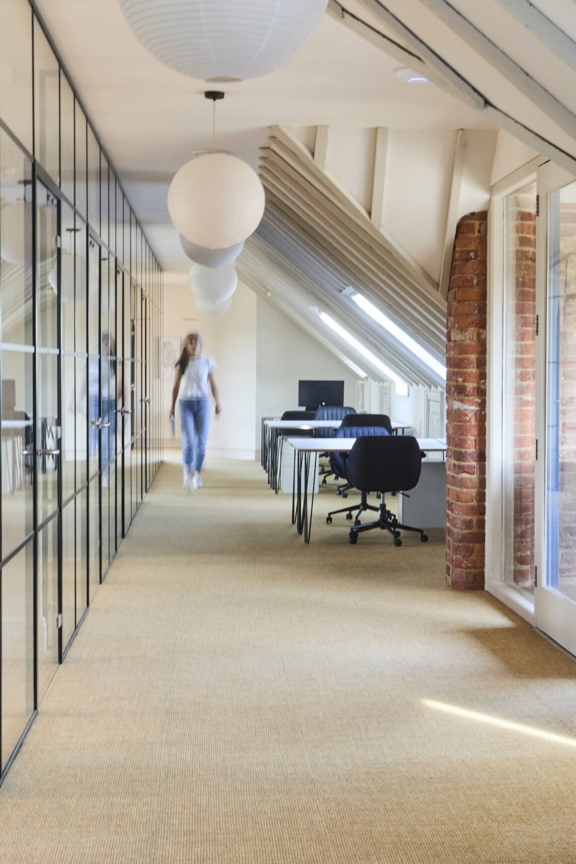 Person walking through a corridor with carpet tile at a wellness-inspired workplace